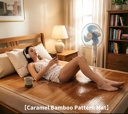 Woman lying on a caramel bamboo pattern mat in a bedroom with a fan and books in the background.