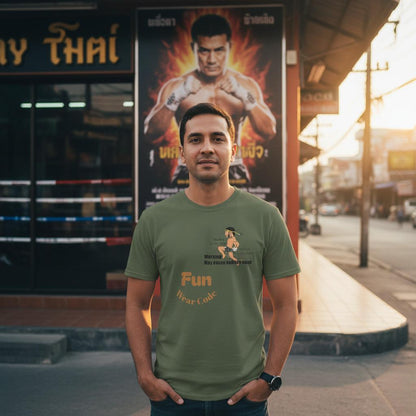 A man wearing a green Thai boxer design tee stands in front of a Thai boxer poster
