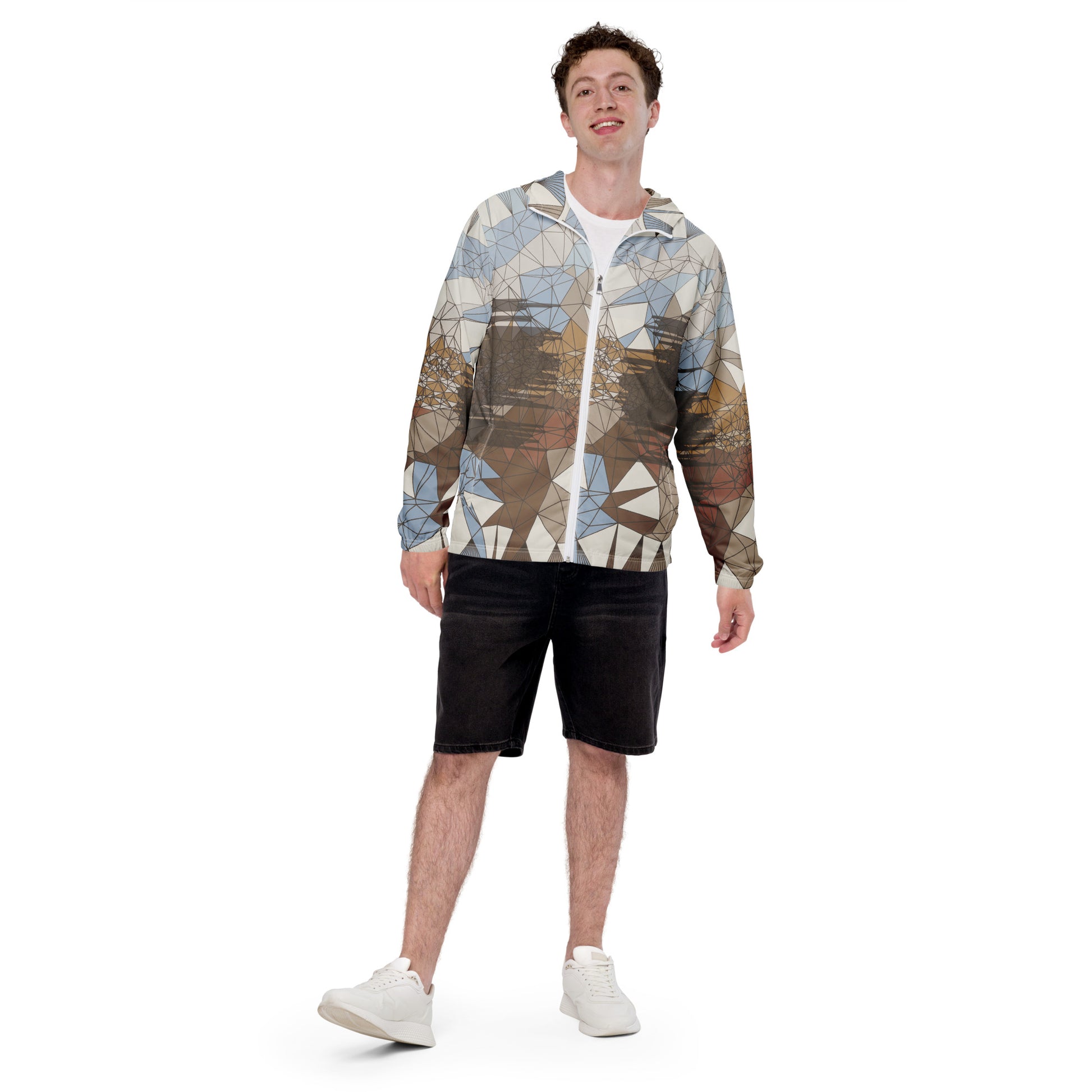 Person wearing a geometric patterned windbreaker and black shorts on a white background