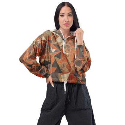 Woman wearing a cropped multicolor geometric patterned windbreaker jacket and black pants on a white background