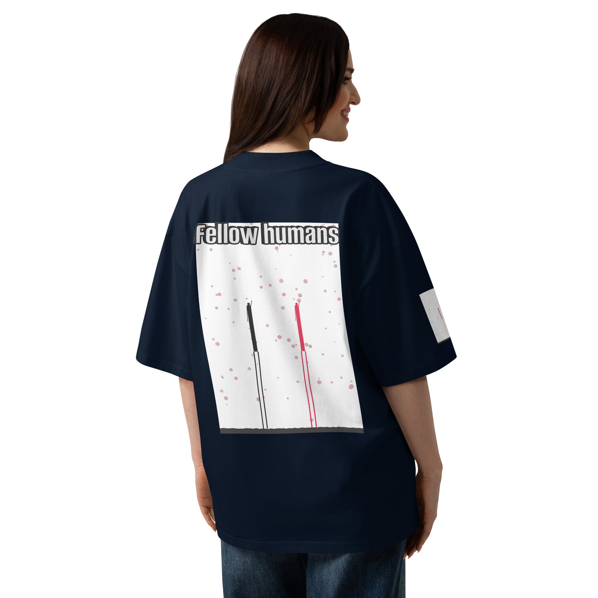 Person wearing a navy blue t-shirt with a graphic design on the back, featuring the text 'Fellow humans'.