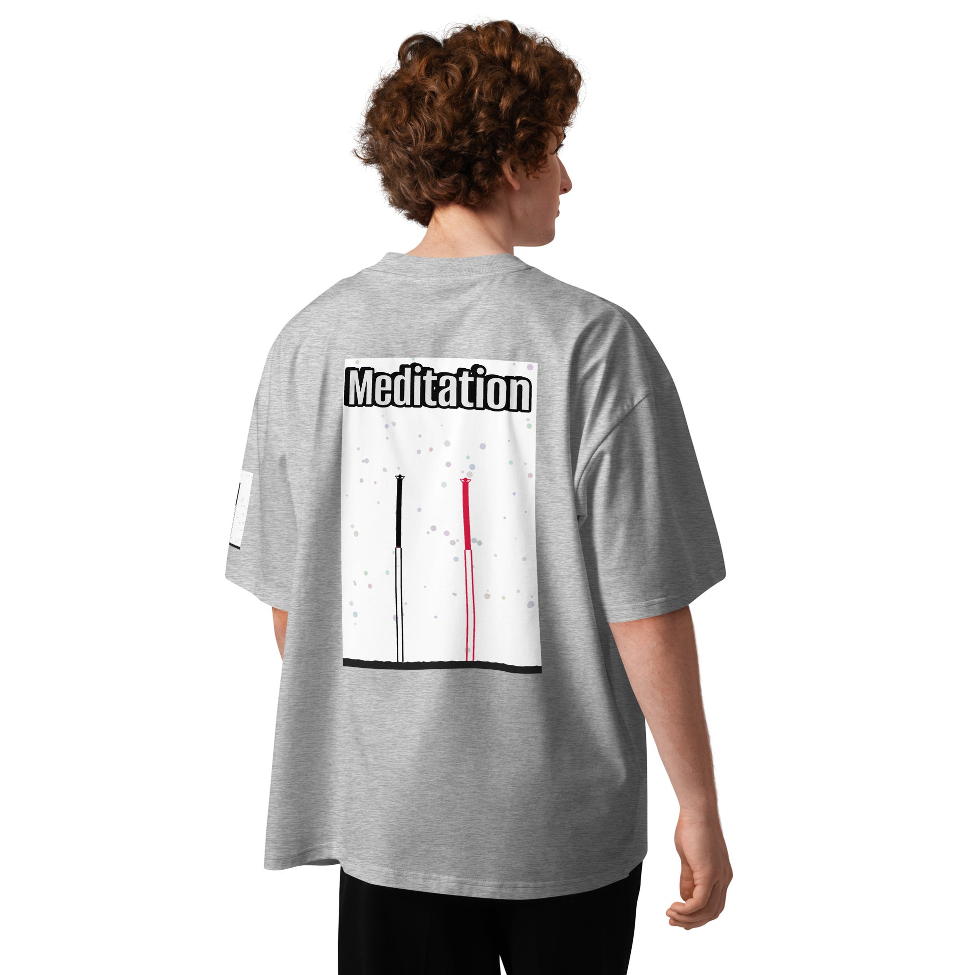 Person wearing a gray t-shirt with 'Meditation' text and two abstract long-leg human graphic on the back, standing against a white background