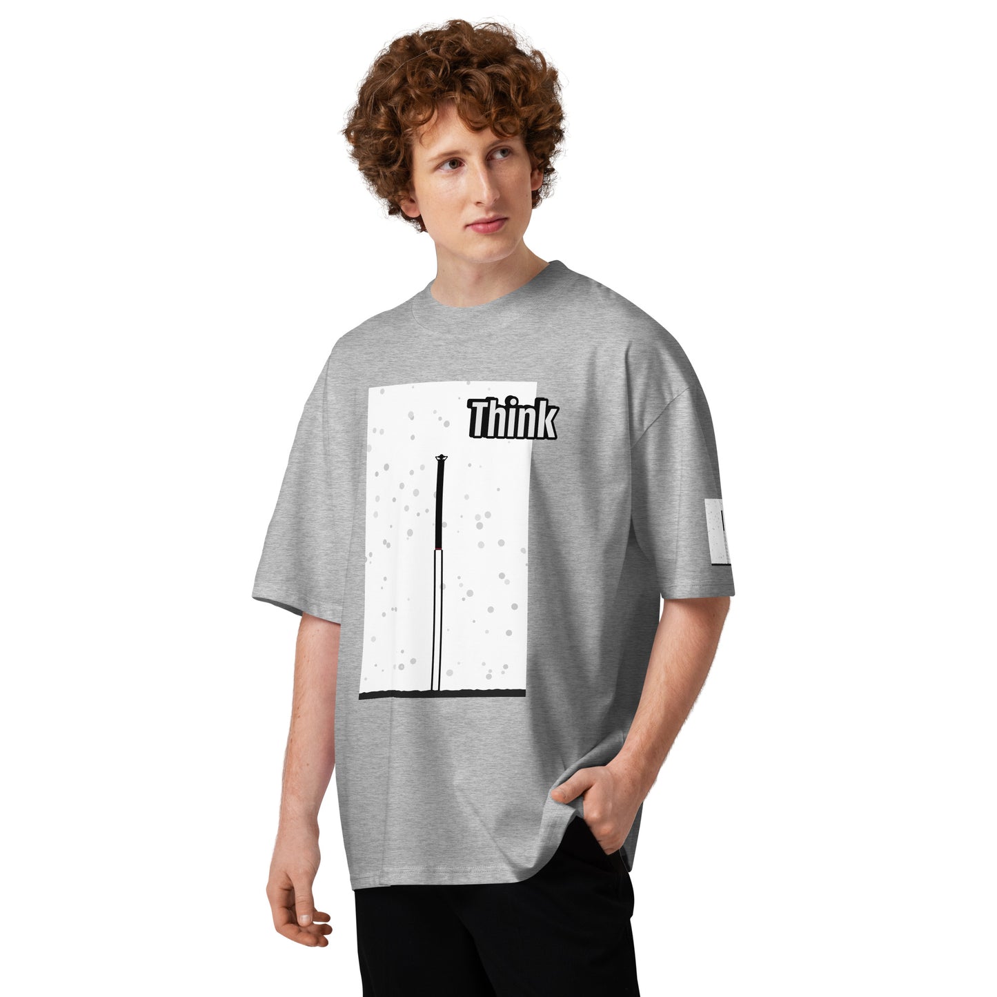 Person wearing a gray t-shirt with an abstract long-leg human graphic design and text on a white background